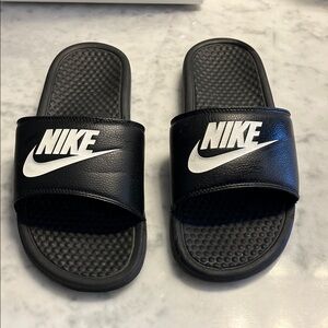 Black Nike slides fits ladies 8 to 9 or men’s seven